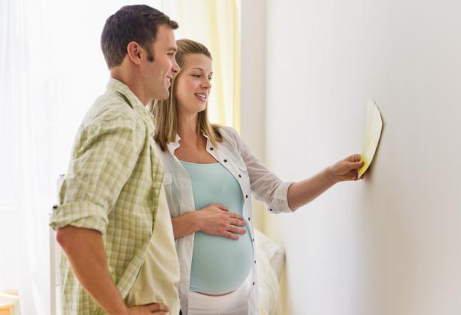 USA, New Jersey, Jersey City, Young couple choosing wall color for nursery