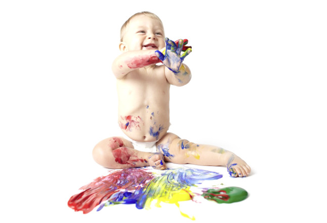 Baby playing with paints