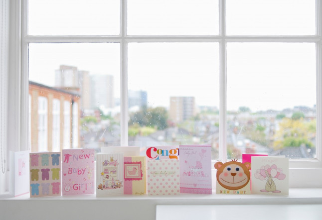 Greetings cards for new baby girl on windowsill