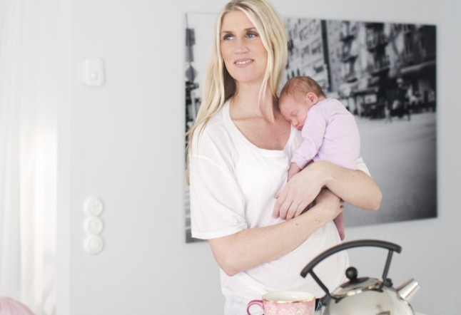 Woman holding newborn daughter
