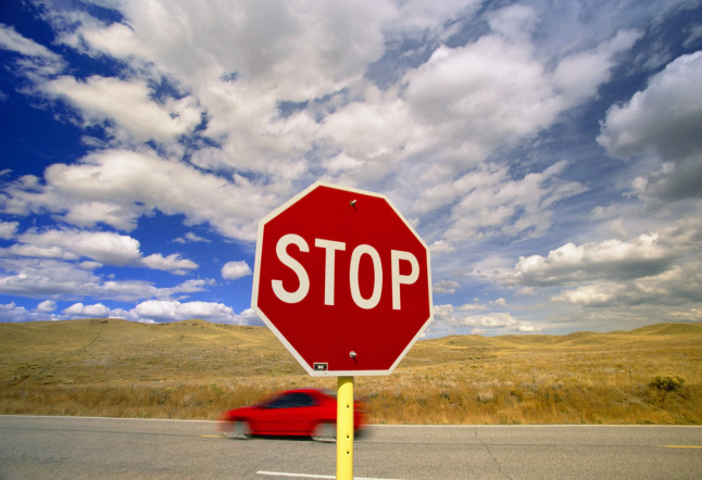 Stop Sign Against Blue Sky and Cumulus Clouds