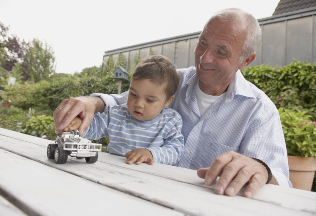 Man and Grandson Playing with Toy Car